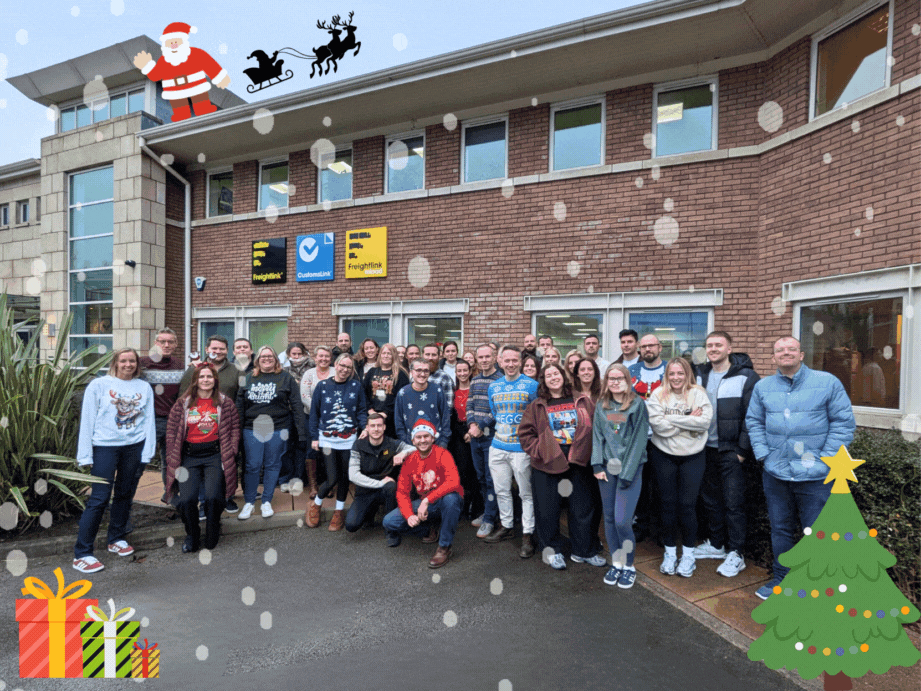 The Freightlink team outside our office wearing Christmas jumpers